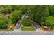 Main entrance to community with brick pillars, manicured landscaping and lush greenery at 25305 Plantation Ne Dr, Atlanta, GA 30324