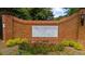 Brick entrance to the The Plantation at Lenox community with manicured landscaping at 25305 Plantation Ne Dr, Atlanta, GA 30324