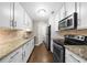 Bright kitchen features granite countertops, white cabinets, and stainless steel appliances at 25305 Plantation Ne Dr, Atlanta, GA 30324