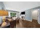 Living room featuring a fireplace, hardwood floors and a balcony with wooded views at 25305 Plantation Ne Dr, Atlanta, GA 30324