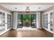 Bright sunroom featuring hardwood floors, neutral paint, and a cozy balcony area with nature views at 25305 Plantation Ne Dr, Atlanta, GA 30324