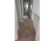 Hallway with carpeting, white trim, and neutral paint, leading to various rooms at 2565 Terrace Trl, Decatur, GA 30035