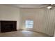Inviting living room featuring a fireplace and abundant natural light through a window at 2565 Terrace Trl, Decatur, GA 30035