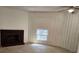 Living room with a fireplace and a small window letting in natural light at 2565 Terrace Trl, Decatur, GA 30035