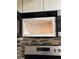 Stainless steel microwave with tiled backsplash and modern appliances at 2565 Terrace Trl, Decatur, GA 30035