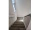 Carpeted staircase with white walls and natural light from the window at 2565 Terrace Trl, Decatur, GA 30035