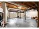 Unfinished basement featuring exposed wood ceiling and two garage doors at 3075 Milford Sw, Marietta, GA 30008