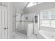 Bright bathroom featuring a glass shower and soaking tub, providing a relaxing and functional space at 3075 Milford Sw, Marietta, GA 30008