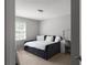 Cozy bedroom features a daybed with soft cushions, a desk, a chair, and a window at 3075 Milford Sw, Marietta, GA 30008