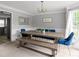Elegant dining room with wooden table, stylish seating, and abundant natural light from the window at 3075 Milford Sw, Marietta, GA 30008