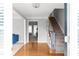 Inviting foyer with hardwood floors, staircase, and view into the living room featuring elegant decor at 3075 Milford Sw, Marietta, GA 30008