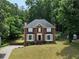 Charming two-story brick home with manicured lawn and mature trees in a peaceful, wooded setting at 3075 Milford Sw, Marietta, GA 30008