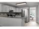 Modern kitchen with stainless steel appliances, white cabinetry, granite countertops, and breakfast nook at 3075 Milford Sw, Marietta, GA 30008