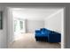 Spacious living area showcasing a blue sofa and large windows, offering ample natural light at 3075 Milford Sw, Marietta, GA 30008