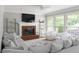 Bright living room with fireplace, large windows, and comfortable seating area with plush sofa and chairs at 3075 Milford Sw, Marietta, GA 30008
