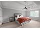 Spacious bedroom featuring a bed with orange blanket, tray ceiling, and a window at 3075 Milford Sw, Marietta, GA 30008