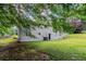 Landscaped backyard with mature trees and shrubbery, offering a private outdoor space at 3920 Stonewall Tell Rd, Atlanta, GA 30349