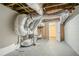 Unfinished basement area with exposed ducts and a doorway leading to another room at 3920 Stonewall Tell Rd, Atlanta, GA 30349
