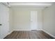 Finished basement room with light-colored walls, wood-look flooring, and two doors at 3920 Stonewall Tell Rd, Atlanta, GA 30349