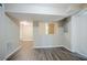 Unfinished basement area with light-colored walls, wood-look flooring, and a small window at 3920 Stonewall Tell Rd, Atlanta, GA 30349