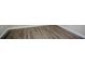 Close-up of the wood-look flooring and trim in a finished basement area at 3920 Stonewall Tell Rd, Atlanta, GA 30349