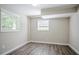 Finished basement room with light-colored walls, wood-look flooring, and two windows at 3920 Stonewall Tell Rd, Atlanta, GA 30349