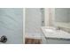 Bright bathroom featuring marble tiled shower, granite countertop, and modern fixtures at 3920 Stonewall Tell Rd, Atlanta, GA 30349