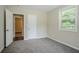 Bedroom featuring carpeted flooring, one window, and multiple access doors at 3920 Stonewall Tell Rd, Atlanta, GA 30349