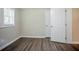 Finished bedroom with light-colored walls, wood-look flooring, a window, and a closet at 3920 Stonewall Tell Rd, Atlanta, GA 30349