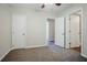 A carpeted bedroom with neutral colors, a ceiling fan, and two closets visible at 3920 Stonewall Tell Rd, Atlanta, GA 30349