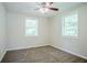 Bright bedroom featuring neutral carpet, ceiling fan, and natural light through large windows at 3920 Stonewall Tell Rd, Atlanta, GA 30349