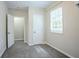 Room with neutral paint, one window, and two access doors at 3920 Stonewall Tell Rd, Atlanta, GA 30349