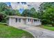 View of home with red door, driveway and professional landscaping at 3920 Stonewall Tell Rd, Atlanta, GA 30349