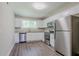 Kitchen with white cabinets, stainless steel appliances and wood flooring at 3920 Stonewall Tell Rd, Atlanta, GA 30349