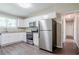 Bright kitchen with white cabinets, granite countertops, stainless appliances and wood flooring at 3920 Stonewall Tell Rd, Atlanta, GA 30349