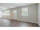 Bright living room with windows allowing natural light and beautiful wood flooring at 3920 Stonewall Tell Rd, Atlanta, GA 30349
