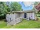 Back of the home featuring a walkout basement, a gray exterior, and lush green yard at 3920 Stonewall Tell Rd, Atlanta, GA 30349