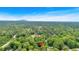 An aerial view shows a home surrounded by dense trees with a mountain visible in the distance at 450 S Susan Creek Dr, Stone Mountain, GA 30083