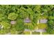 An aerial view shows a home nestled among lush green trees with an adjacent stream at 450 S Susan Creek Dr, Stone Mountain, GA 30083