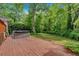 A wooden back deck with hot tub offers privacy and relaxation amongst mature trees at 450 S Susan Creek Dr, Stone Mountain, GA 30083