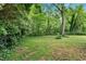 A tranquil backyard with mature trees provides privacy and a nature filled setting at 450 S Susan Creek Dr, Stone Mountain, GA 30083
