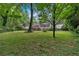 Large grassy backyard with plenty of space, mature trees, and lush greenery at 450 S Susan Creek Dr, Stone Mountain, GA 30083