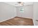 Comfortable bedroom with wood-look floors, neutral walls, and a bright window at 450 S Susan Creek Dr, Stone Mountain, GA 30083