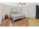 Cozy bedroom featuring wood-look floors, neutral walls, and a window at 450 S Susan Creek Dr, Stone Mountain, GA 30083