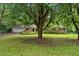Ranch-style home with a brick and siding exterior, surrounded by mature trees and a lush green lawn at 450 S Susan Creek Dr, Stone Mountain, GA 30083