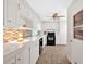 Bright kitchen features white cabinets, modern appliances, and stylish tile backsplash at 450 S Susan Creek Dr, Stone Mountain, GA 30083