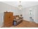 Comfortable living space featuring hardwood floors, a decorative light fixture, and neutral wall colors at 450 S Susan Creek Dr, Stone Mountain, GA 30083