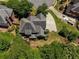 Aerial view of home showcasing a large lot, well-manicured lawn, mature trees, and a spacious driveway at 935 Brookline Way, Alpharetta, GA 30022