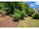 Picturesque backyard featuring mature trees, lush greenery, and manicured landscaping at 935 Brookline Way, Alpharetta, GA 30022