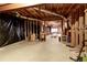 Unfinished basement featuring exposed ductwork, framing, concrete floor and some personal property at 935 Brookline Way, Alpharetta, GA 30022
